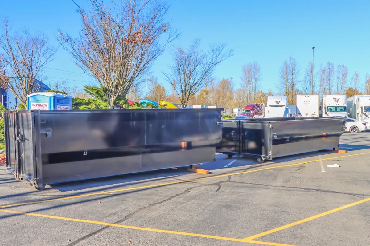 Professional dumpster rental service with roll-off container on residential driveway in Villas